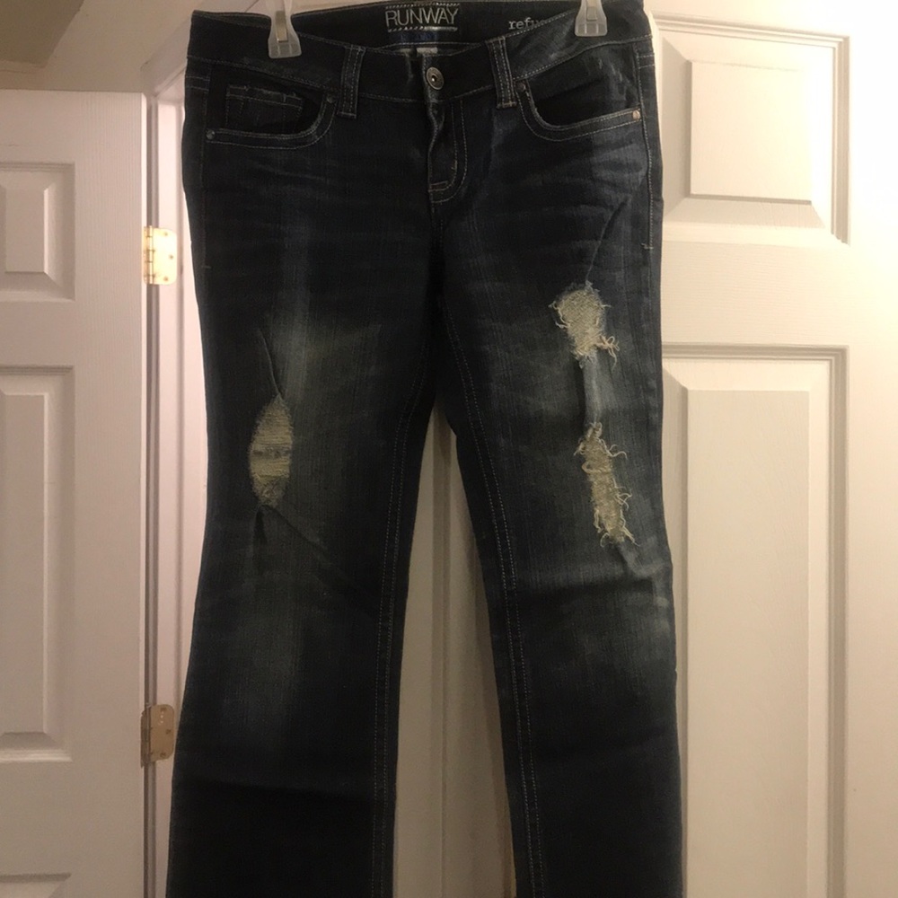 Never worn. Ripped jeans.